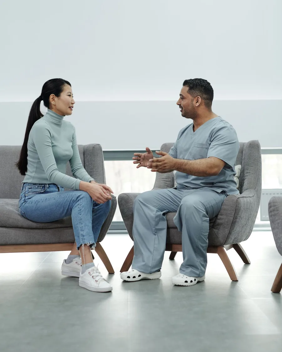 A clinician talking with a patient during a consultation